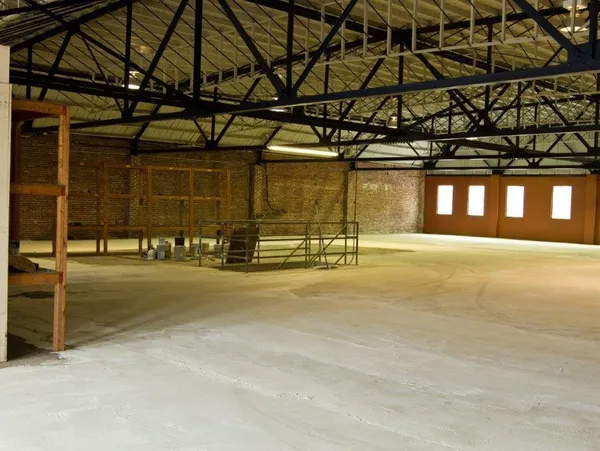 2012: The Raw Space Open floors, black metal trusses, exposed brick, and natural light — the perfect blank canvas.